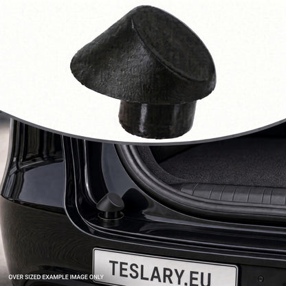 A black textured car trunk lid release cap shown floating above a black Tesla car trunk, with a small inset of the cap and a license plate reading TESLARY.EU. Tesla Trunk Rubber Stopper 1507940-00-C and 1507942-00-C Buy from Ireland and Europes teslary.eu