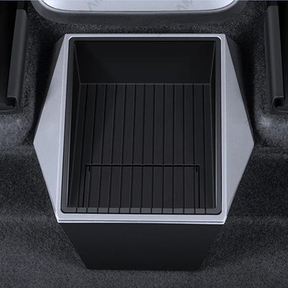 A black and silver car cup holder organizer insert with a slotted tray, shown installed in a carpeted car console.