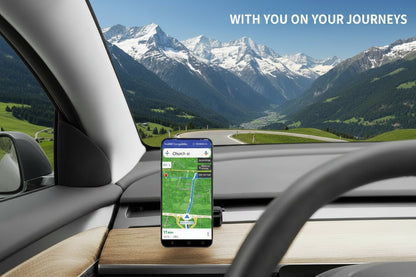 A smartphone mounted on a dashboard holder inside a car, displaying a navigation app screen. The phone is positioned on a wood-grain dashboard with a steering wheel in the foreground and a bridge view through the windshield. TESLA_MODEL_3_MODEL_Y_SUPER_MAGNET_DASH_PHONE_MOUNT_WITH_PRONGS_BUY_FROM_IRELAND_AND_EUROPES_TESLARY.EU