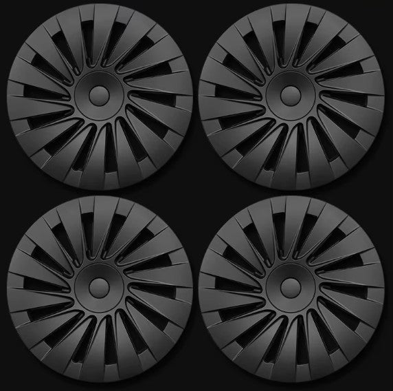Four black hubcaps with a multi-spoke radial design, arranged in a 2x2 grid on a black background.